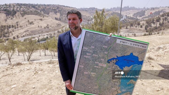 File photo of Israeli Finance Minister Bezalel Smotrich holding  a map of a land corridor known as E1 taken near the Maale Adumim settlement in the West Bank, on August 14, 2025.
