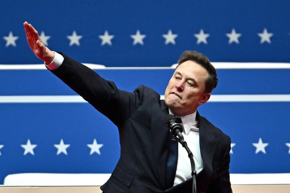 Tesla and SpaceX CEO Elon Musk gestures as he speaks during the inaugural parade inside Capitol One Arena, in Washington, DC, on January 20, 2025.