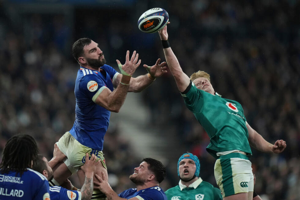 France's Charles Ollivon, left, and Ireland's Tommy O'Brien challenge for the ball during a Six Nations rugby match.