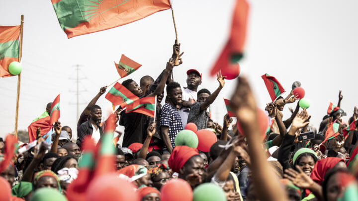 Supporters of Angolan opposition party National Union for the Total Independence of Angola (UNITA) wave party flags during the UNITA final campaign rally ahead of general elections, Luanda, August 22, 2022.