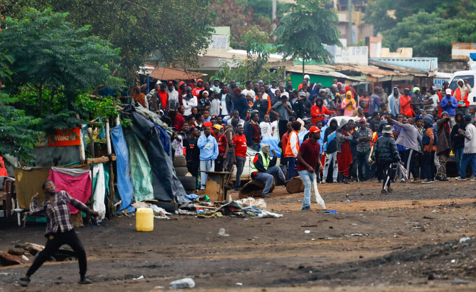Demonstrators participate in a protest a day after a general election marred by violent demonstrations over the exclusion of two leading opposition candidates.