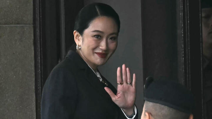Thailand's suspended Prime Minister Paetongtarn Shinawatra waves as she arrives at Government House in Bangkok on August 29, 2025.