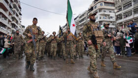 Syrian army members take part in a military parade in Latakia, Syria, on December 8, 2025.