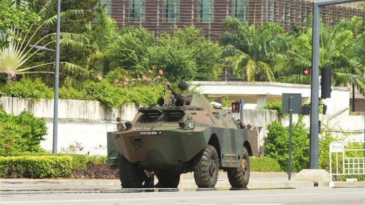 Beninese soldiers take up positions in front of the headquarters of Benin's radio and television station in Cotonou.