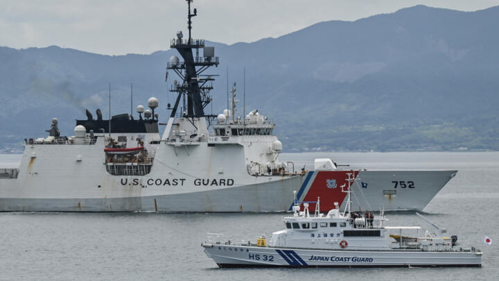 The United States Coast Guard ship Cutter Stratton (L) sails past a smaller Japan Coast Guard vessel during exercises this week