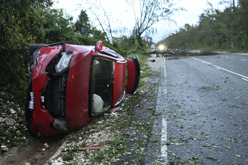 A car damaged by a fallen tree is seen after Hurricane Melissa passed through Manchester, Jamaica, on October 29, 2025.