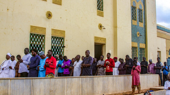 Nigerien worshippers gather for a mass prayer at the great mosque in Niger's capital Niamey, August 11, 2023.