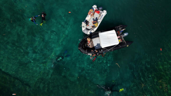 A drone view shows archaeologists diving in the lake of Ohrid to uncover objects, in the village of Lin, Albania, July 11, 2025.