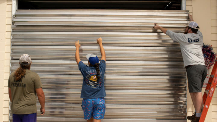 Volunteers place hurricane shutters at the Cedar Key Fire Station ahead of the arrival of Hurricane Idalia in Cedar Key, Florida, US on August 29, 2023.