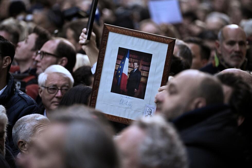 Supporters of Sarkozy sang the national anthem as they gathered outside his residence in Paris.
