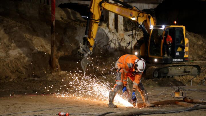 This photograph shows a worker at the Saint-Denis Pleyel Station, at Seine-Saint-Denis on the outskirts of Paris on February 5, 2021.