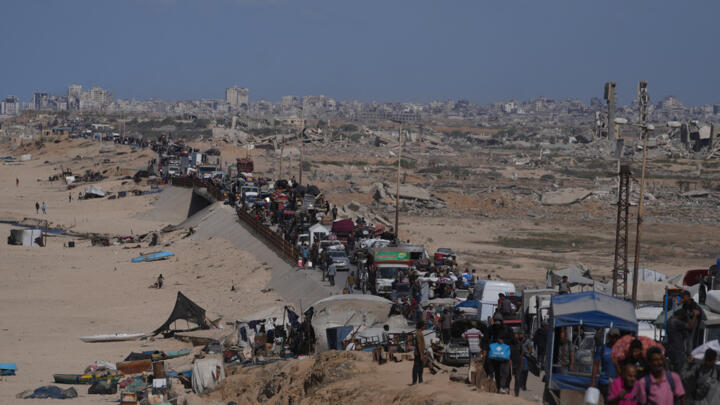 Displaced Palestinians walk along the coastal road toward Gaza city, Saturday, October 11, 2025.