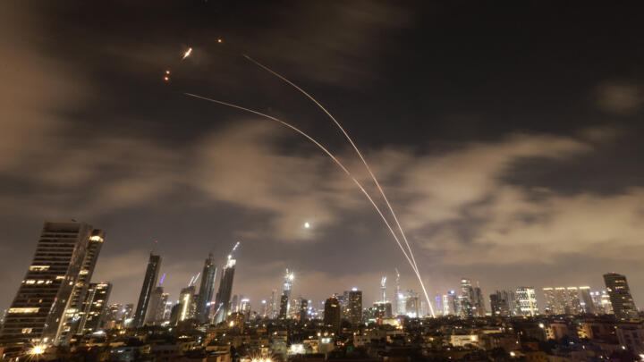 Israeli air defence systems are activated to intercept Iranian missiles over the Israeli city of Tel Aviv early on June 18, 2025. 