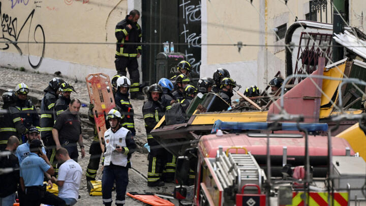 First responders work at the site of an accident involving Lisbon's Gloria funicular, a popular tourist attraction, which derailed and crashed, resulting in fatalities and injuries, according to autho