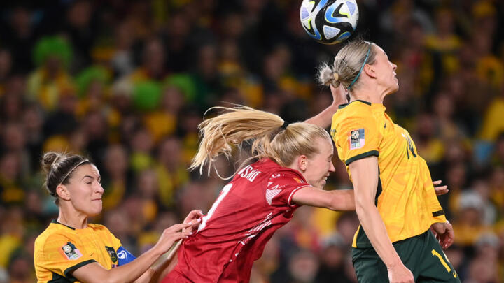 Denmark's forward Amalie Vangsgaard (C) fights for the ball with Australia's defender Alanna Kennedy (R) at the 2023 Women's World Cup.