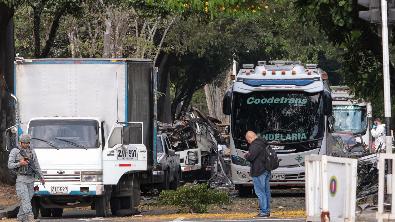 Members of Colombian security forces inspect the area of a bomb explosion in Cali, Colombia, where at least 12 people were killed and dozens were injured.