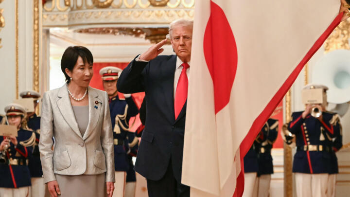 Japan's Prime Minister Sanae Takaichi (L) and US President Donald Trump review an honour guard in Tokyo on October 28, 2025.