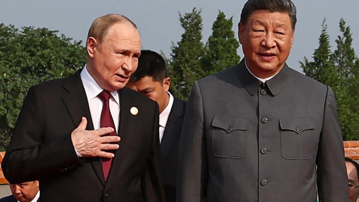 Russia's President Vladimir Putin walks with China's Xi Jinping before a military parade in Beijing's Tiananmen Square on September 3, 2025.