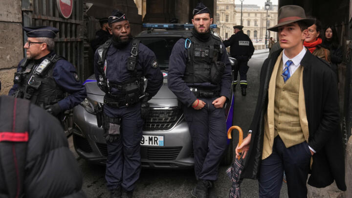 Police officers block an access to the Louvre museum after a robbery on October 19, 2025, in Paris.