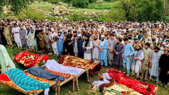 Mourners and locals offer funeral prayers for victims who died in incidents related to flash floods and monsoon rains in Salarzai Tehsil of Pakistan's Bajaur district on August 15, 2025.