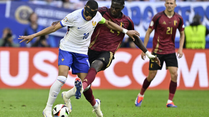 Kylian Mbappe holds off Amadou Onana during the Euro 2024 last-16 clash between France and Belgium in Duesseldorf on Monday.