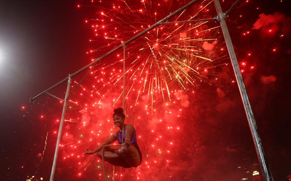 A girl performs the traditional Indian sport of mallakhamb during Diwali, the Hindu festival of lights, in Mumbai on October 22, 2025.