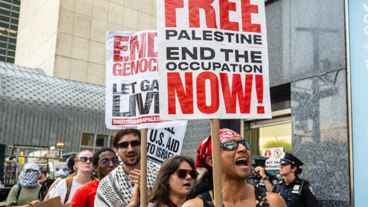 People participate in a protest in support of Palestine outside the UN as a conference on Palestine and a two-state solution takes place inside the UN on July 29, 2025 in New York City.