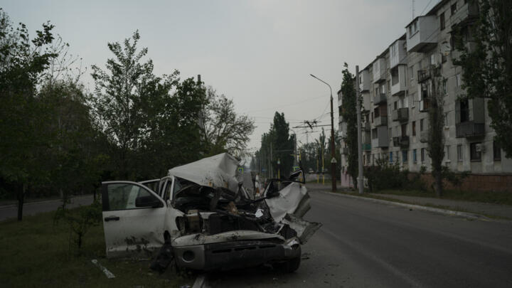 A heavily damaged car is seen on a street after a Russian attack in Severodonetsk, Luhansk region, Ukraine, Friday, May 13, 2022.