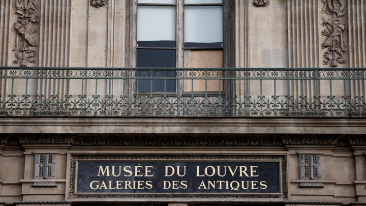 View of a broken window protected by a wooden panel at the Louvre Museum a day after a spectacular jewel heist by thieves who broke into the landmark by using a crane.