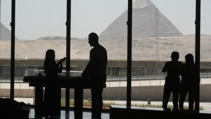 Tourists view the site of the great Pyramids from the rest zone of the Grand Egyptian Museum in Giza, Egypt on May 23, 2025.
