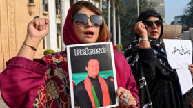 Supporters of Pakistan's imprisoned former prime minister Imran Khan's supporters hold his portrait during a protest in Lahore on January 17, 2025.