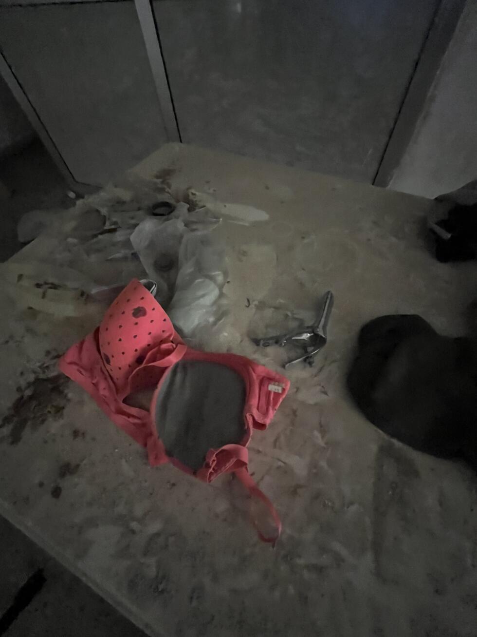 A vaginal speculum and a bra lie on a dusty table near the cells of the Palestine Branch, Damascus, May 29, 2025.