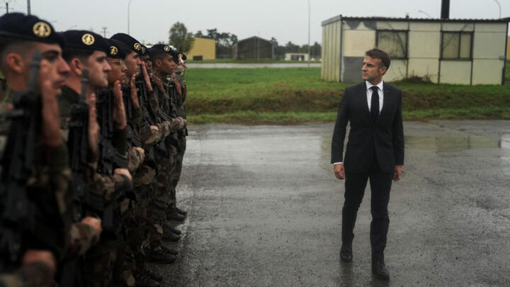 France's President Emmanuel Macron reviews troops during a visit in a military camp in eastern France on October 9, 2024.