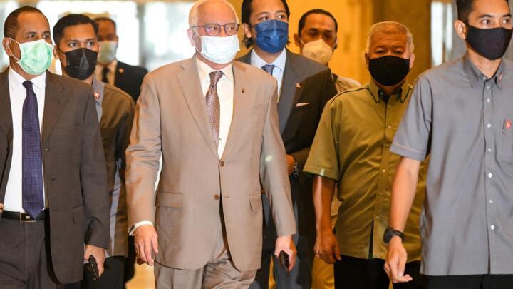 Malaysian former prime minister Najib Razak (C) arrives at the court of appeal in Putrajaya on April 5, 2021.