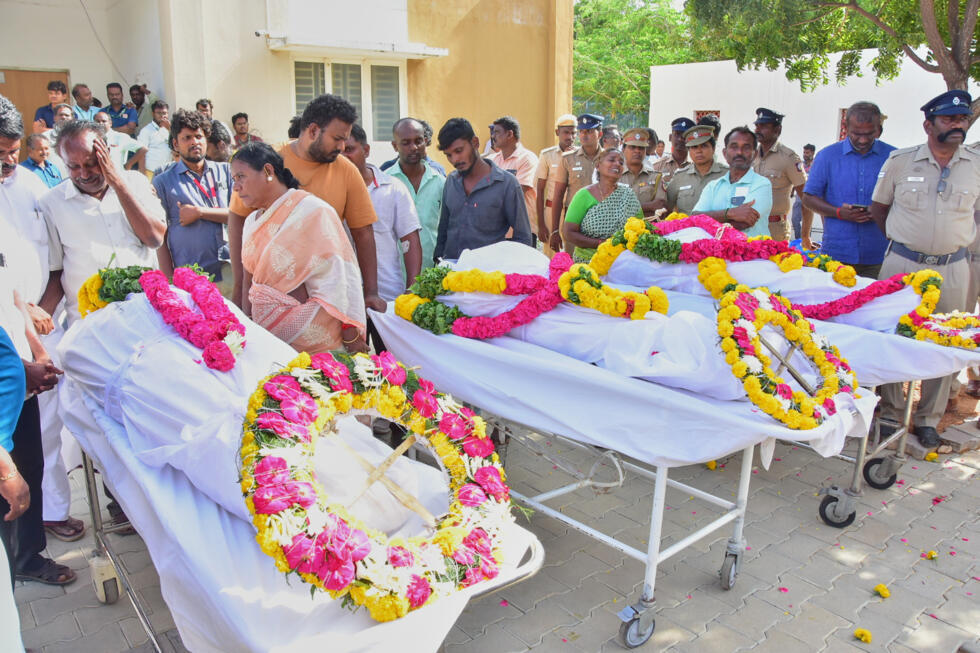 Relatives of people who were killed in a stampede during a political rally, mourn near their bodies  in Karur, in the southern state of Tamil Nadu, Sunday, September 28, 2025.