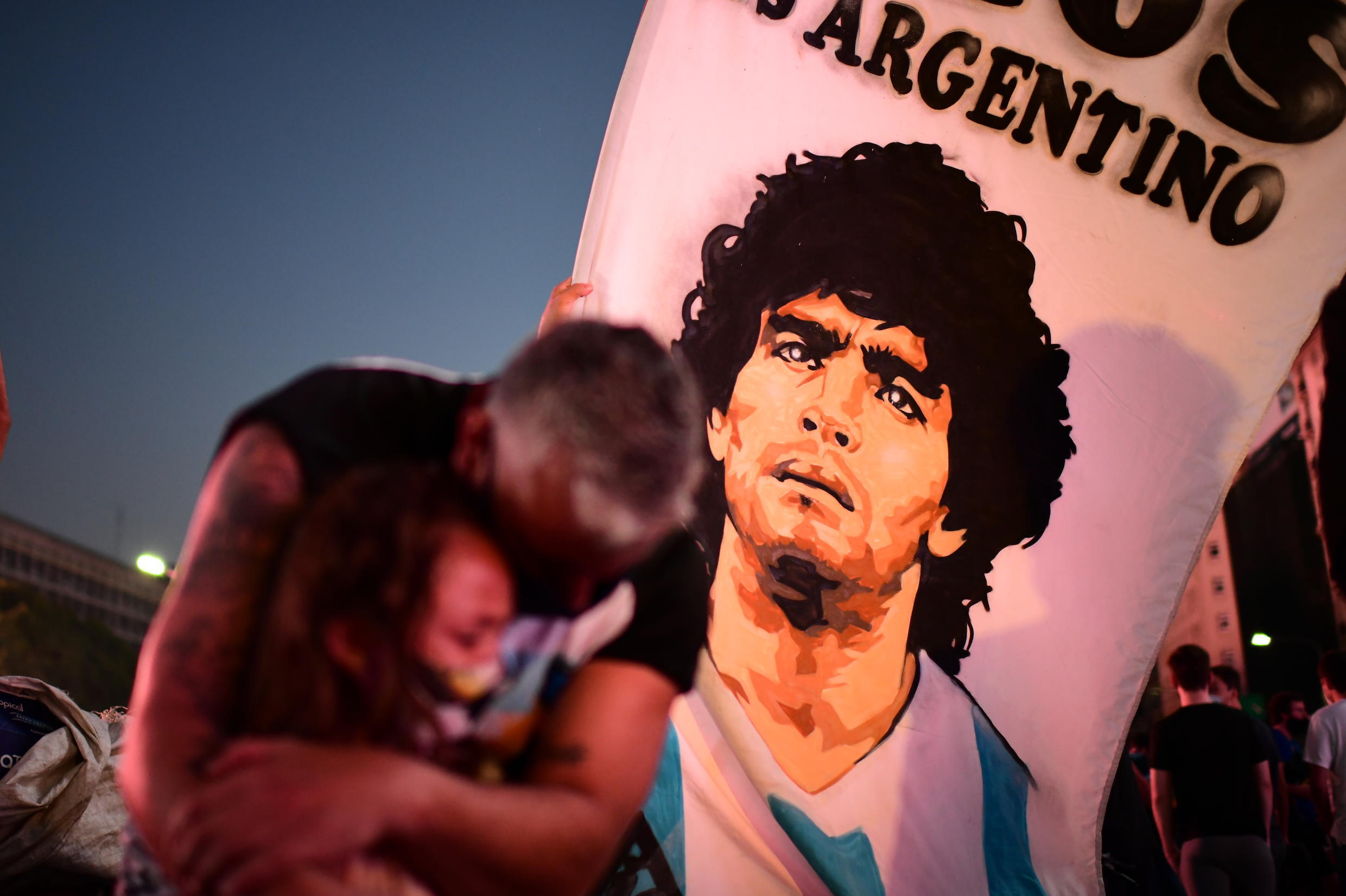 Father and child mourn the death of Diego Maradona in Buenos Aires on November 25.