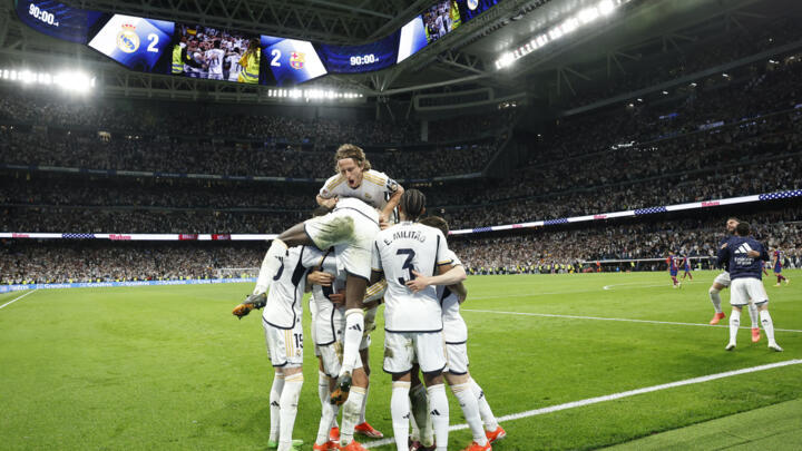 Real Madrid players celebrate their third goal scored by Real Madrid's at the Santiago Bernabeu stadium in Madrid on April 21, 2024.