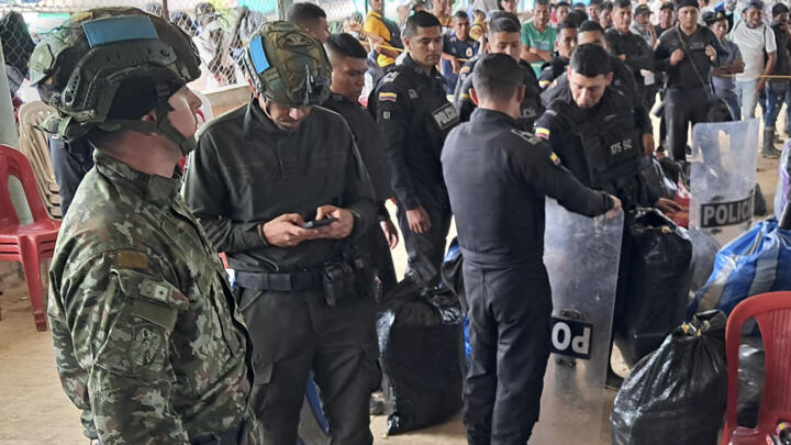 Some of the 28 policemen and one soldier who had been taken captive by dissident members of the FARC rebel group, wait for their transfer after being released in El Plateado, Cauca department, Colombi
