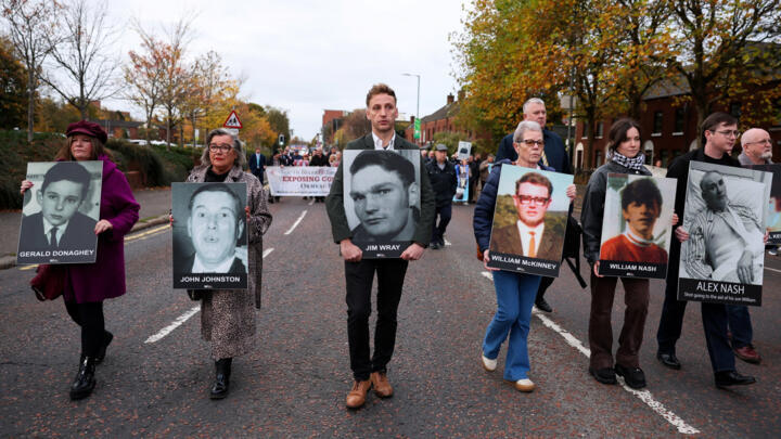 Family members hold pictures of victims of the 1972 'Bloody Sunday', as a judge is expected to give a verdict on the trial of the British army veteran known as 'Soldier F'.