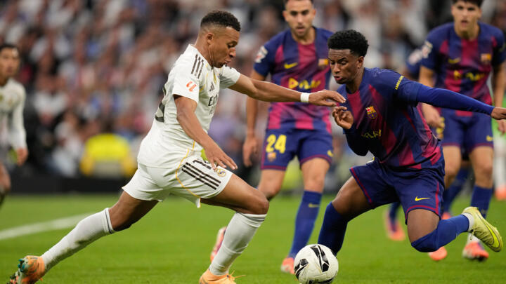 Barcelona's Alejandro Balde guards Real Madrid's Kylian Mbappé during a La Liga soccer match between Real Madrid and Barcelona in Madrid, Spain, Sunday, October 26, 2025. 