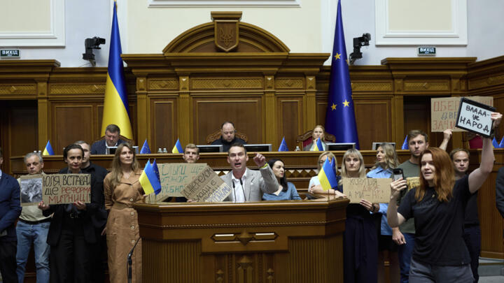 Ukrainian lawmakers are calling to vote for a new bill proposed by President Volodymyr Zelenskyy restoring the independence of the country's anti-corruption agencies at the parliament session hall in 