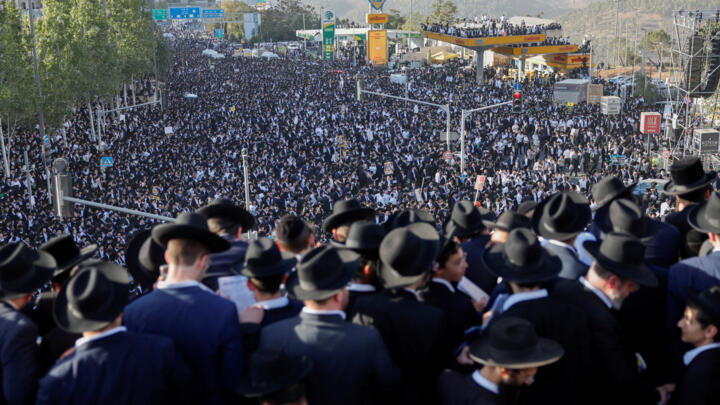 Ultra-Orthodox Jewish men gather on and below the Chords Bridge during the "Million Man" protest against Israeli military conscription in Jerusalem, October 30, 2025.