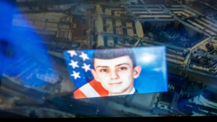 This photo illustration created on April 13, 2023 shows the Discord logo and the suspect, Jack Teixeira, reflected in an image of the Pentagon in Washington, DC.