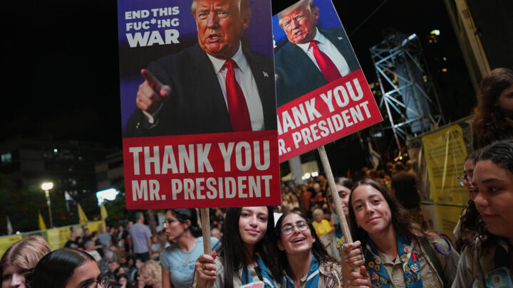 People with images depicting the US President Donald Trump take part in a rally in support of hostages kidnapped by Hamas in Tel Aviv, Israel, Saturday, October 11, 2025.