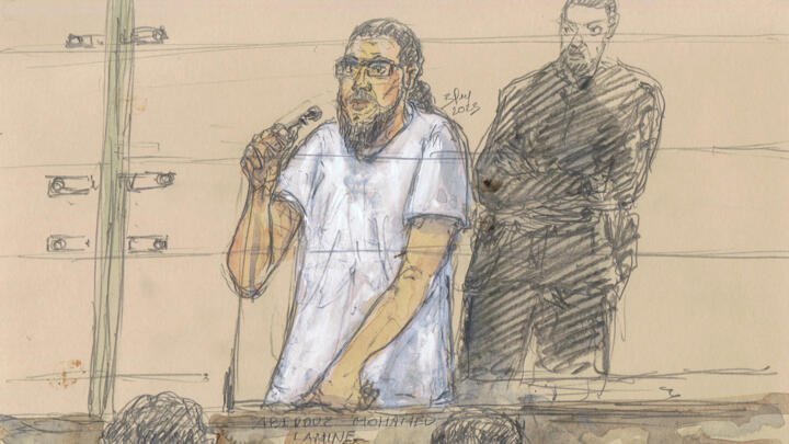 A court sketch made on September 25, 2023, shows Mohamed Lamine Aberouz (R) attending the second day of the Magnanville attack trial at Paris courthouse.