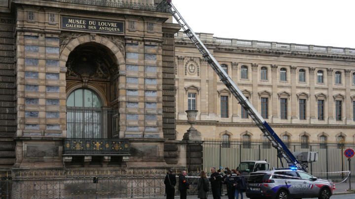 French police officers stand next to a furniture life used by robbers to enter the Louvre Museum, on Quai Francois Mitterrand, in Paris on October 19, 2025. 