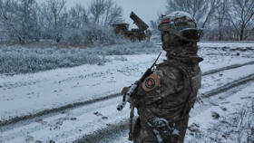 A Russian soldier guards an area at a "Grad" self-propelled multiple rocket launcher preparing to fire towards Ukrainian positions on an undisclosed location in Ukraine.