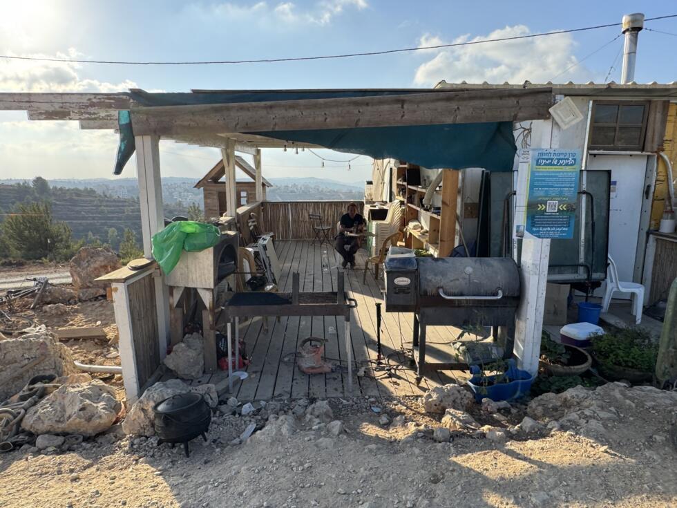 Lior Tal in front of his house which overlooks Palestinian villages in the West Bank. 
