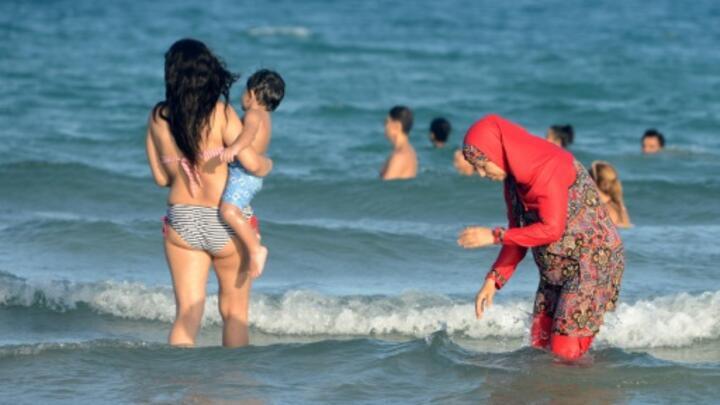 A row over the "burkini", a full-body swimsuit for Muslim women seen here in Tunisia, has temporarily closed two public pools in Grenoble.