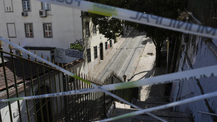 Police tape cordons-off the access to the tracks of the Gloria funicular, a tourist streetcar that derailed and crashed, in Lisbon on September 5, 2025.